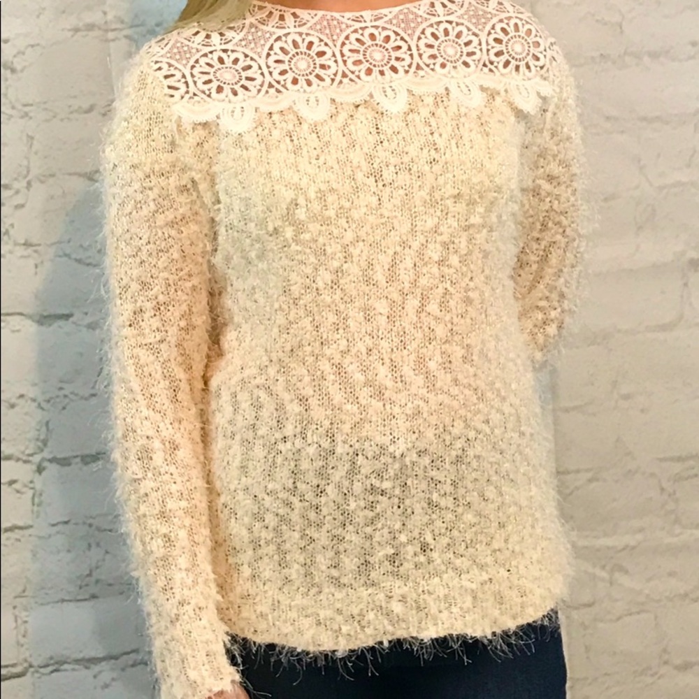 Brand new furry sweater with cut outs along the neckline.